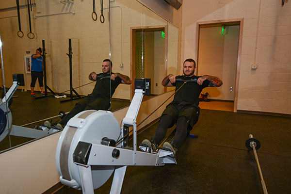 man using a rower